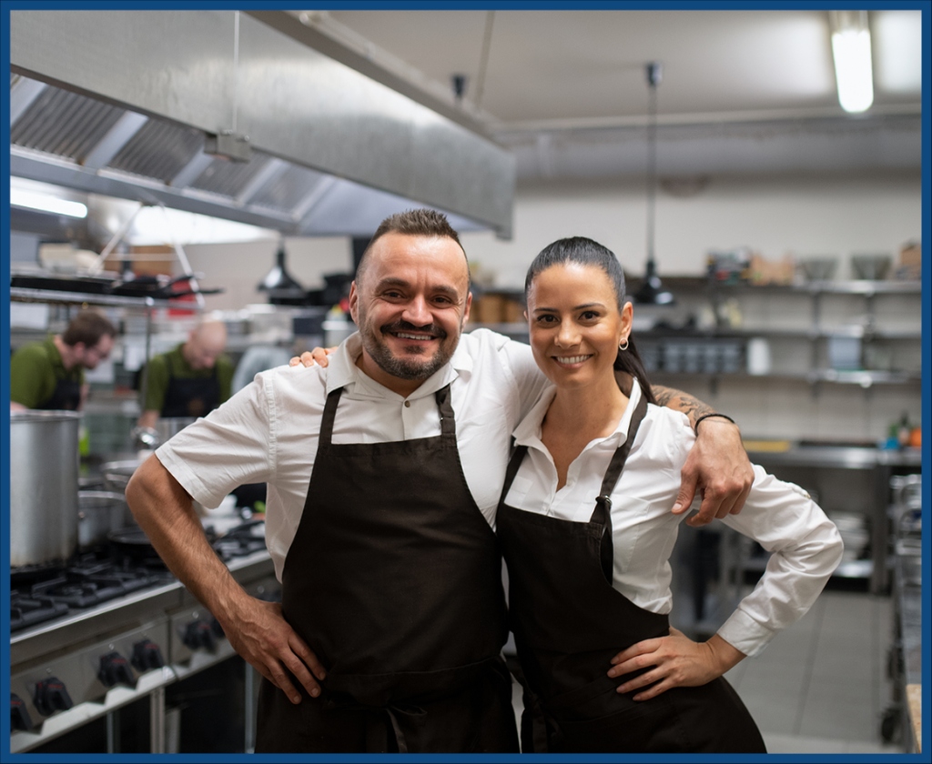Restaurant owners smiling